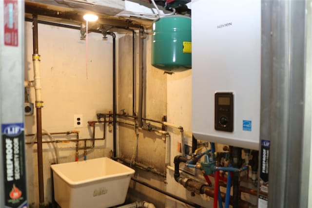 113 6th Ave, Huntington Station, NY 11746 - utility room featuring tankless water heater and a sink