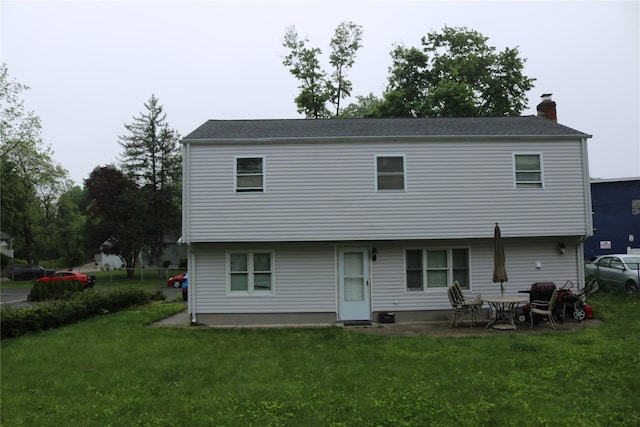 113 6th Ave, Huntington Station, NY 11746 - rear view of house with a lawn and a chimney