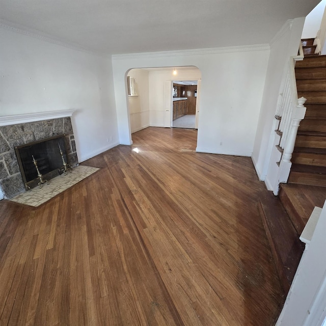 78-10 222nd St, Oakland Gardens, NY 11364 - unfurnished living room with arched walkways, stairway, crown molding, a fireplace, and wood finished floors