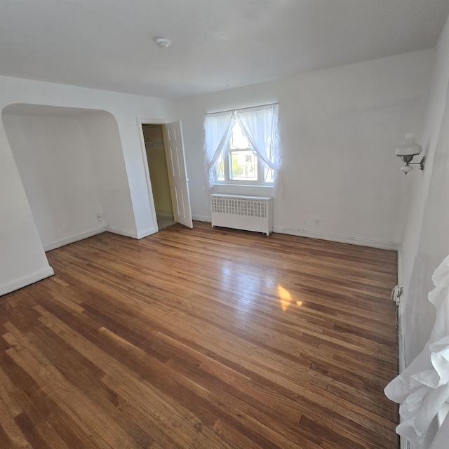 78-10 222nd St, Oakland Gardens, NY 11364 - unfurnished room with radiator, wood finished floors, and baseboards