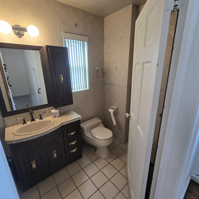 78-10 222nd St, Oakland Gardens, NY 11364 - bathroom with tile walls, vanity, toilet, and tile patterned floors