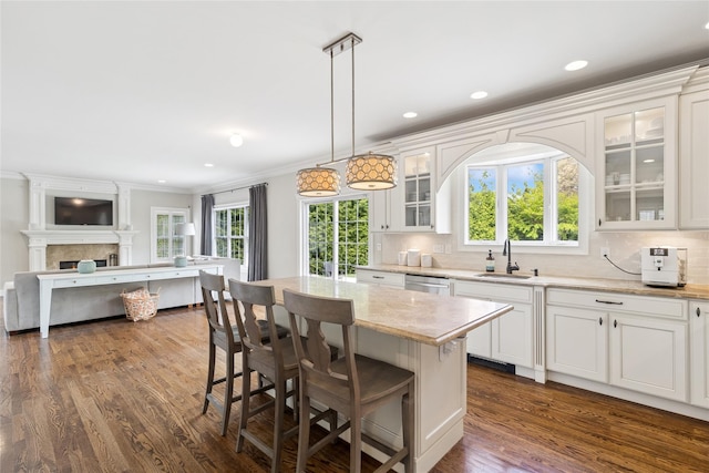 38 Savanna Cir, Mount Sinai, NY 11766 - kitchen with a sink, a kitchen breakfast bar, open floor plan, white cabinetry, and glass insert cabinets