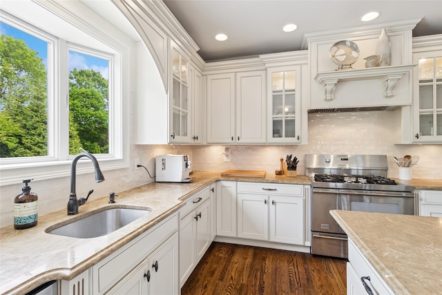 38 Savanna Cir, Mount Sinai, NY 11766 - kitchen with stainless steel gas range, a sink, white cabinets, decorative backsplash, and dark wood-style flooring