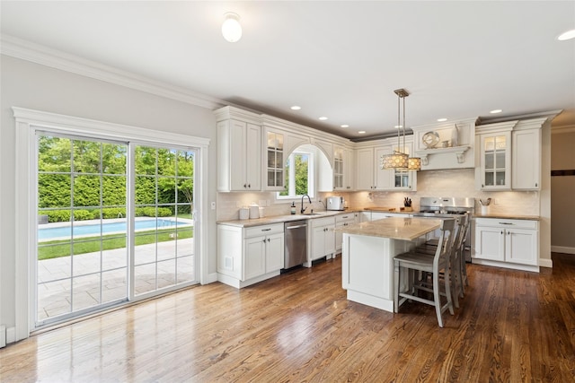 38 Savanna Cir, Mount Sinai, NY 11766 - kitchen featuring appliances with stainless steel finishes, a sink, tasteful backsplash, a center island, and dark wood-style flooring