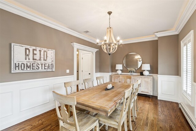 38 Savanna Cir, Mount Sinai, NY 11766 - dining room featuring a baseboard radiator, a chandelier, ornamental molding, wainscoting, and dark wood-type flooring