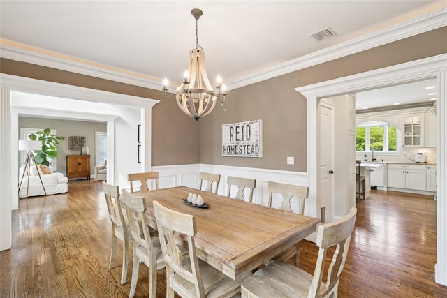 38 Savanna Cir, Mount Sinai, NY 11766 - dining room featuring a chandelier, crown molding, and light wood-type flooring