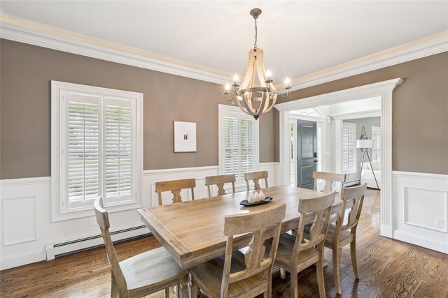 38 Savanna Cir, Mount Sinai, NY 11766 - dining area featuring a baseboard heating unit, wainscoting, a chandelier, ornamental molding, and wood finished floors