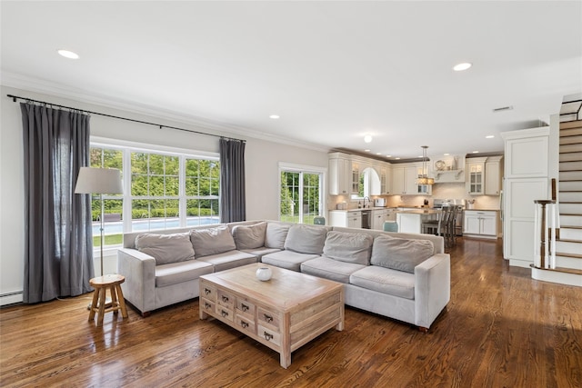 38 Savanna Cir, Mount Sinai, NY 11766 - living area featuring ornamental molding, recessed lighting, dark wood-type flooring, stairs, and a baseboard radiator