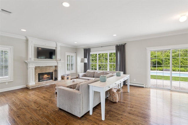 38 Savanna Cir, Mount Sinai, NY 11766 - living room featuring a baseboard radiator, crown molding, wood finished floors, a fireplace, and baseboards
