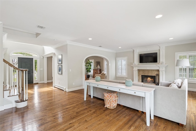 38 Savanna Cir, Mount Sinai, NY 11766 - living room featuring a baseboard heating unit, wood finished floors, stairway, a large fireplace, and baseboards