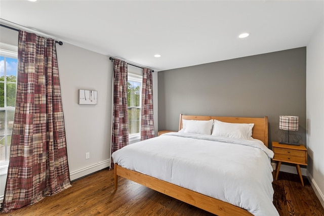 38 Savanna Cir, Mount Sinai, NY 11766 - bedroom featuring a baseboard heating unit, multiple windows, wood finished floors, baseboards, and recessed lighting