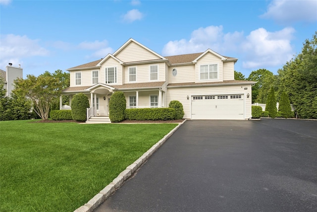 38 Savanna Cir, Mount Sinai, NY 11766 - view of front of house featuring a garage, driveway, a front lawn, and roof with shingles