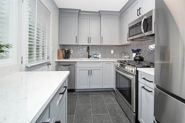 4 Peck Unit 47A, Rye, NY 10580 - kitchen with appliances with stainless steel finishes, a sink, gray cabinets, backsplash, and dark tile patterned flooring