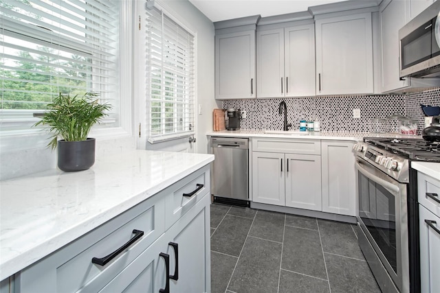 4 Peck Unit 47A, Rye, NY 10580 - kitchen with appliances with stainless steel finishes, a sink, gray cabinets, and decorative backsplash