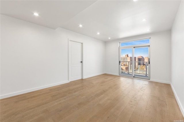 97-29 64th Rd Unit 7E, Rego Park, NY 11374 - empty room featuring light wood-style flooring, baseboards, and recessed lighting
