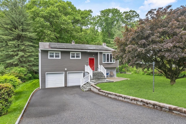209 Laurel Dr, Cortlandt Manor, NY 10567 - split foyer home featuring roof mounted solar panels, asphalt driveway, and a front yard