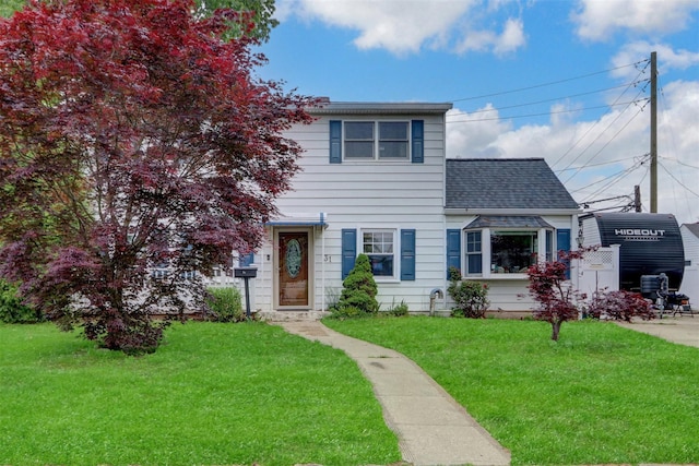 31 Clover Ln, Levittown, NY 11756 - view of front facade with a front yard and roof with shingles