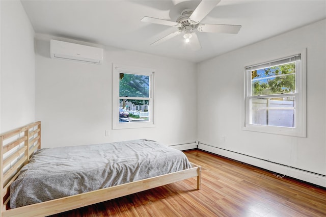 31 Clover Ln, Levittown, NY 11756 - bedroom featuring an AC wall unit, multiple windows, baseboard heating, and wood finished floors
