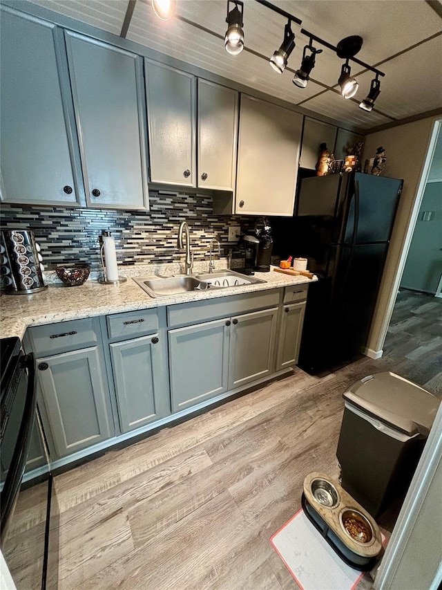 150 Rinaldi Blvd Unit 1C, Poughkeepsie, NY 12601 - kitchen featuring a sink, freestanding refrigerator, light wood-type flooring, and light countertops