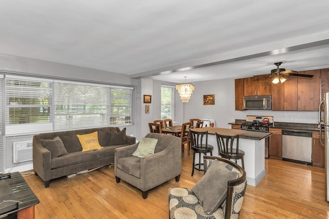 12427 Flatlands Ave Unit 1A, Brooklyn, NY 11208 - living room featuring light wood-style flooring, a ceiling fan, and a chandelier