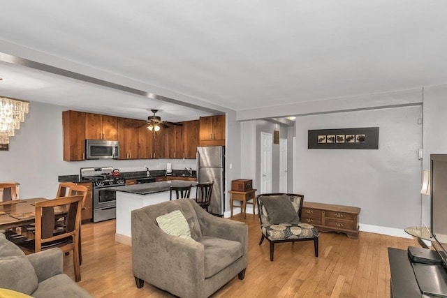 12427 Flatlands Ave Unit 1A, Brooklyn, NY 11208 - living room featuring light wood-style flooring, a ceiling fan, and baseboards