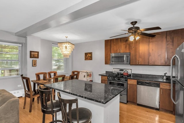 12427 Flatlands Ave Unit 1A, Brooklyn, NY 11208 - kitchen with appliances with stainless steel finishes, light wood-type flooring, a kitchen breakfast bar, and healthy amount of natural light