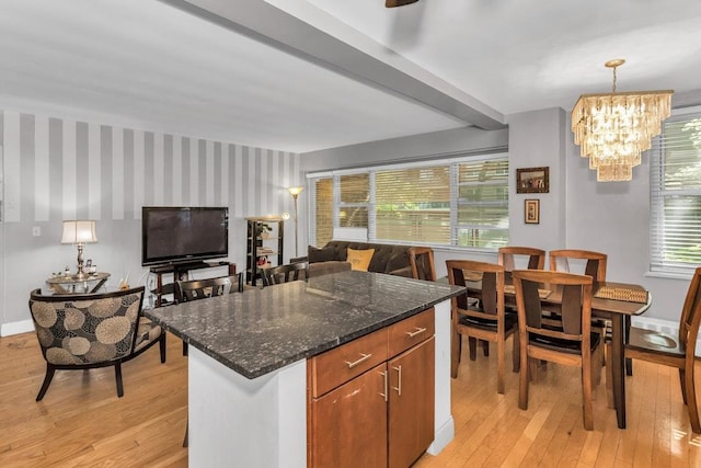 12427 Flatlands Ave Unit 1A, Brooklyn, NY 11208 - kitchen featuring light wood finished floors, baseboards, a chandelier, and dark stone countertops