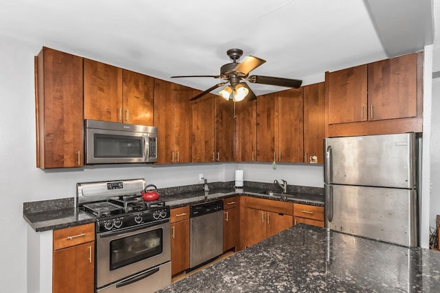 12427 Flatlands Ave Unit 1A, Brooklyn, NY 11208 - kitchen with appliances with stainless steel finishes, ceiling fan, dark stone countertops, a sink, and brown cabinets