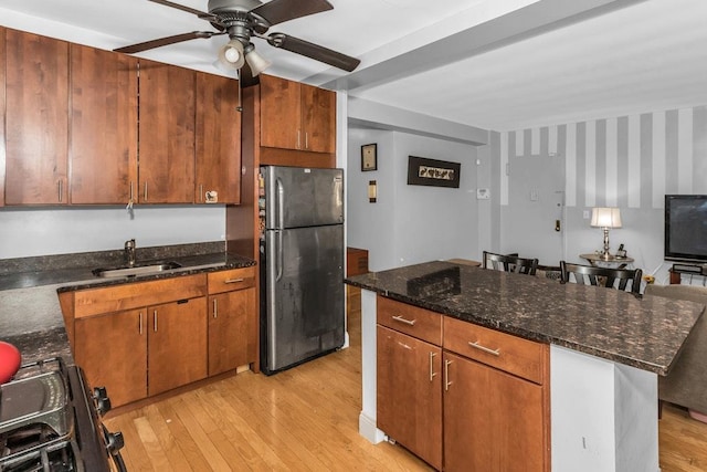 12427 Flatlands Ave Unit 1A, Brooklyn, NY 11208 - kitchen with freestanding refrigerator, a sink, ceiling fan, and light wood finished floors