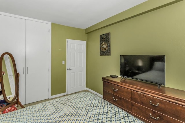 12427 Flatlands Ave Unit 1A, Brooklyn, NY 11208 - bedroom with light carpet, baseboards, and a closet