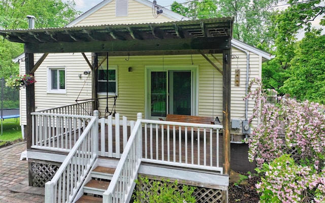 9 Chapel Rd, Newburgh, NY 12550 - back of property with a trampoline, a wooden deck, and stairway
