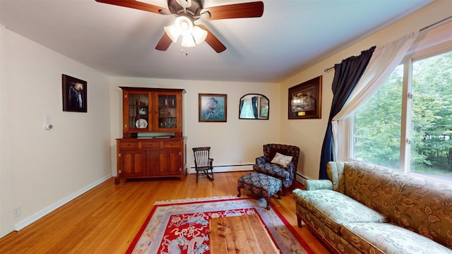 9 Chapel Rd, Newburgh, NY 12550 - living area featuring light wood-style floors, a ceiling fan, a baseboard radiator, and baseboards