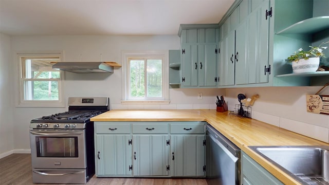 9 Chapel Rd, Newburgh, NY 12550 - kitchen featuring open shelves, appliances with stainless steel finishes, under cabinet range hood, and healthy amount of natural light