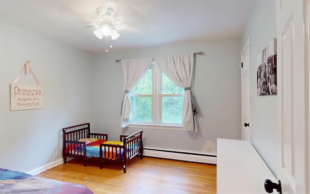 9 Chapel Rd, Newburgh, NY 12550 - bedroom featuring a baseboard radiator, wood finished floors, and baseboards
