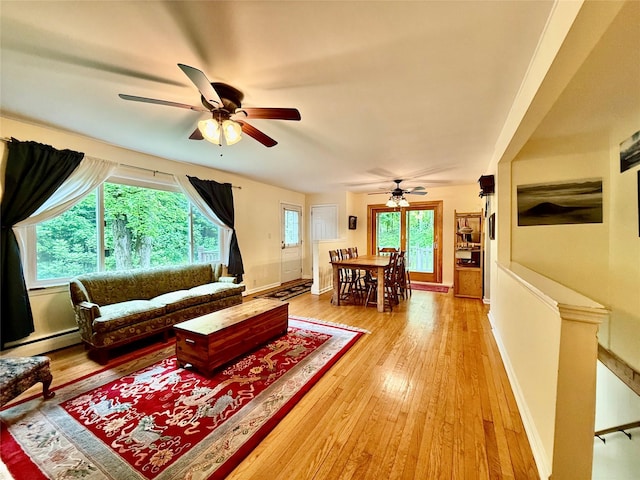 9 Chapel Rd, Newburgh, NY 12550 - living room with ceiling fan, a baseboard radiator, light wood finished floors, and baseboards