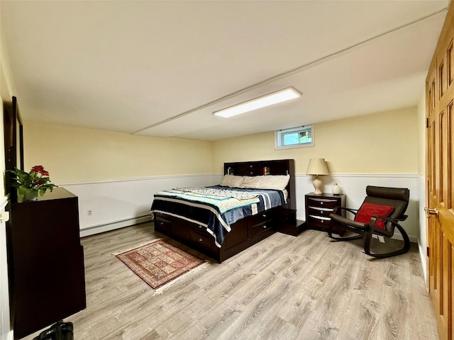 9 Chapel Rd, Newburgh, NY 12550 - bedroom featuring a baseboard heating unit and wood finished floors