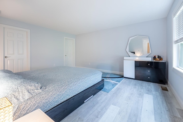5 Teramar Way, White Plains, NY 10607 - bedroom featuring multiple windows, wood finished floors, and baseboards