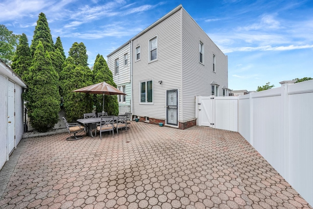 79-48 67th Rd, Middle Village, NY 11379 - rear view of property with a patio, a gate, and a fenced backyard