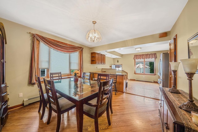 79-48 67th Rd, Middle Village, NY 11379 - dining area featuring a chandelier, a baseboard heating unit, light wood finished floors, baseboards, and baseboard heating