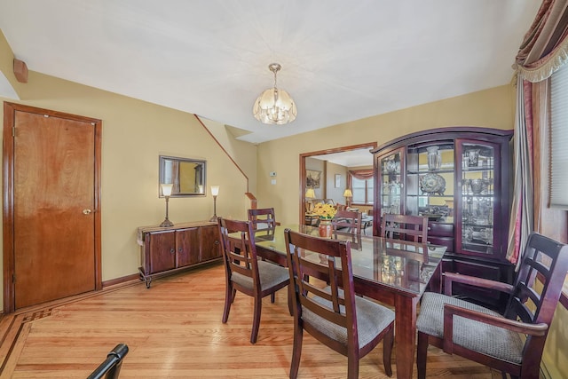 79-48 67th Rd, Middle Village, NY 11379 - dining room featuring a chandelier, light wood-type flooring, and baseboards