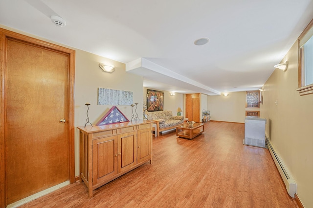 79-48 67th Rd, Middle Village, NY 11379 - corridor featuring a baseboard radiator, light wood-type flooring, and baseboards