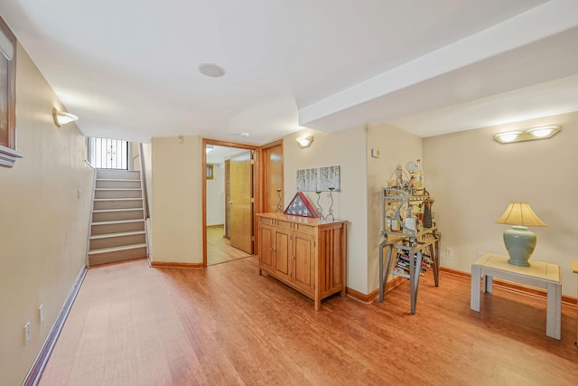 79-48 67th Rd, Middle Village, NY 11379 - below grade area featuring light wood finished floors, stairway, and baseboards