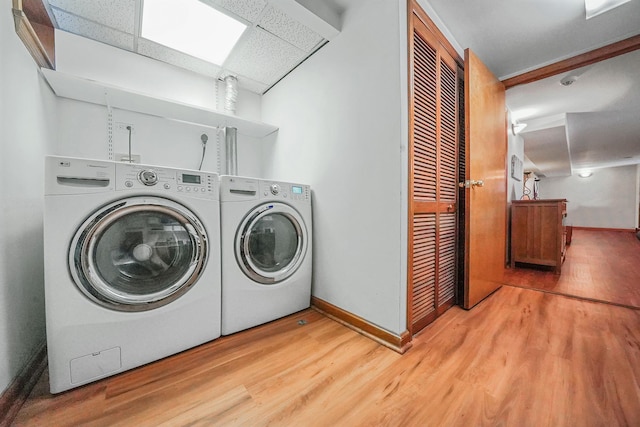 79-48 67th Rd, Middle Village, NY 11379 - laundry room with washing machine and dryer, baseboards, and wood finished floors