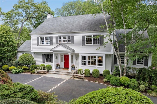 35 Seville Ave, Rye, NY 10580 - view of front facade with a shingled roof and a chimney