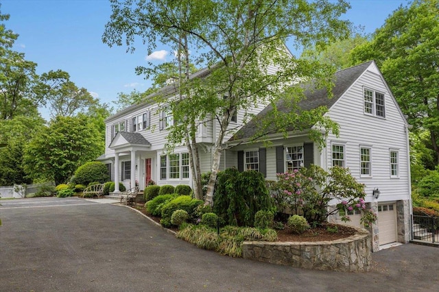 35 Seville Ave, Rye, NY 10580 - view of front of house with asphalt driveway, a garage, and roof with shingles