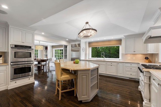 35 Seville Ave, Rye, NY 10580 - kitchen with stainless steel appliances, backsplash, white cabinetry, custom exhaust hood, and dark wood-style floors