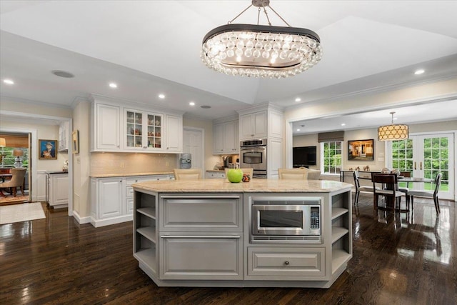 35 Seville Ave, Rye, NY 10580 - kitchen with open shelves, appliances with stainless steel finishes, crown molding, white cabinets, and a kitchen island