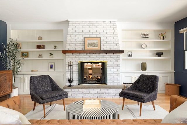 135 Turk Hill Rd, Carmel, NY 10509 - living area with light wood-type flooring, built in shelves, and a brick fireplace