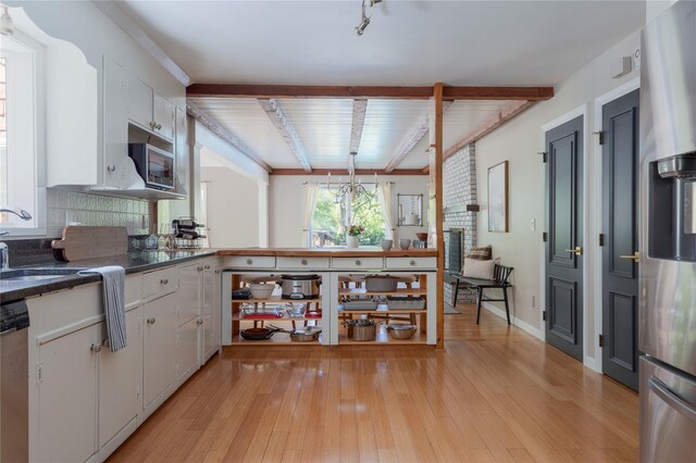 135 Turk Hill Rd, Carmel, NY 10509 - kitchen with stainless steel microwave, white cabinetry, light wood finished floors, beamed ceiling, and dark countertops