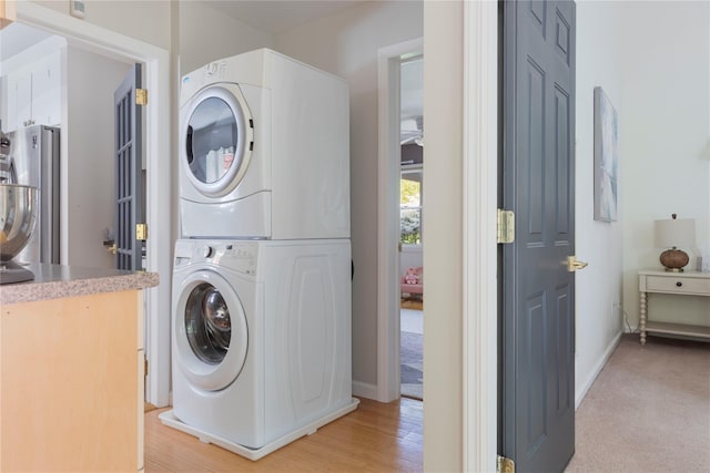 135 Turk Hill Rd, Carmel, NY 10509 - laundry room with estacked washer and dryer, baseboards, and light wood-style flooring